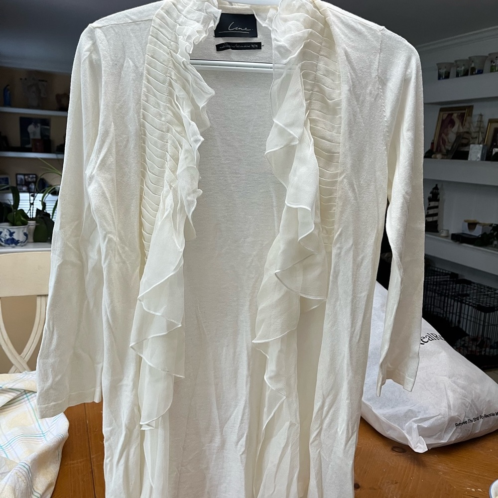 Crème cardigan with sheer 100% silk trim.